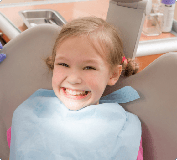 Young girl grinning in dental chair