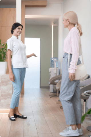 Woman talking to dental office receptionist