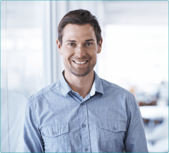 Man in blue buttoned shirt smiling after preventive dentistry in Bangor