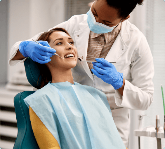 Woman having her mouth examined by dentist