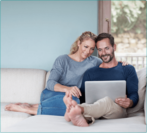 Man and woman looking at laptop for dentist reviews in Bangor