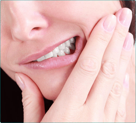 Close up of person holding their cheek in pain