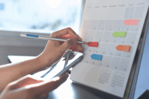 Close up of patient editing their calendar with small sticky notes