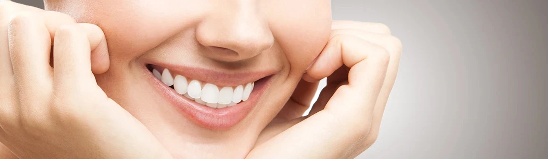 A Close Up of a Woman Smiling with Her Head Cradled in Her Hands Our Services